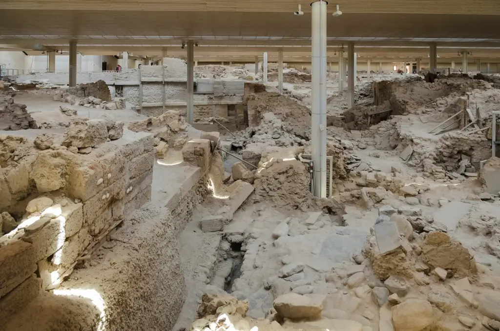 Excavated stone walls and streets of the Bronze Age town at Akrotiri under the site's protective roof