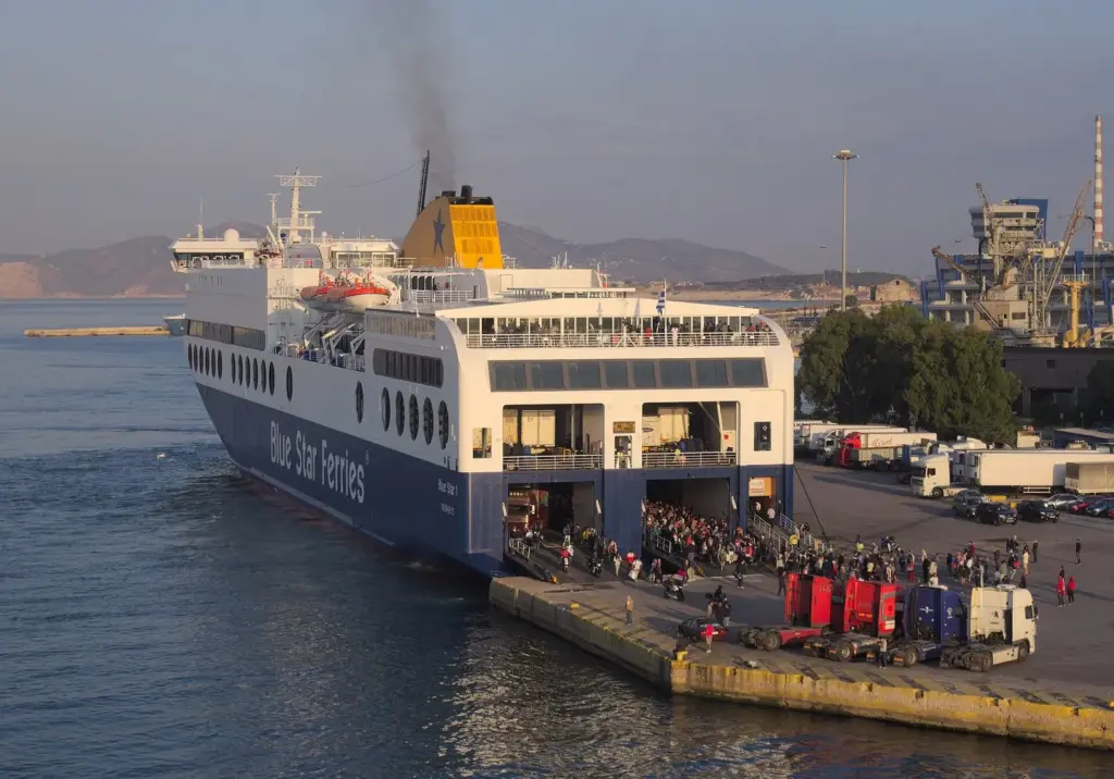 Passengers and vehicles streaming off the Blue Star 1 ferry onto the quay at Piraeus