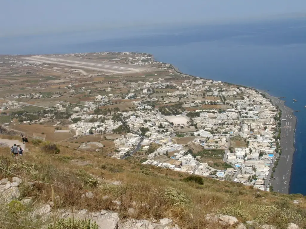 Kamari village and the Santorini airport runway on the island's flat east coast seen from Ancient Thera