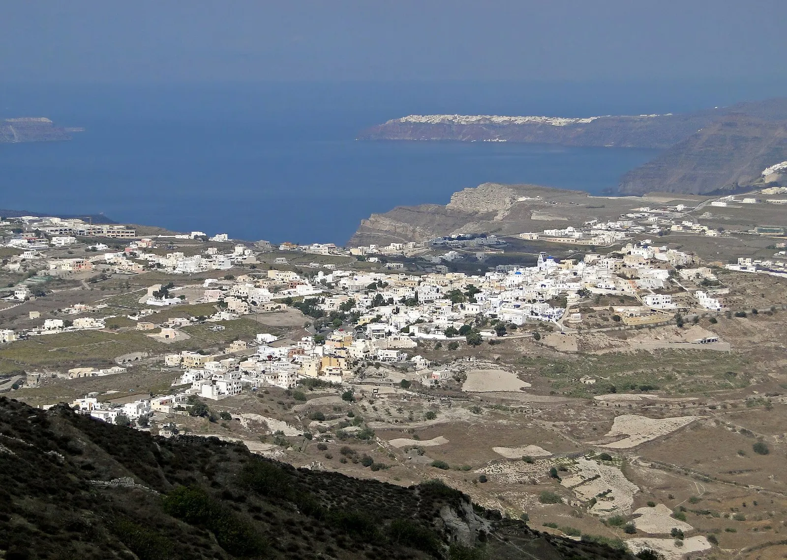 Santorini villages seen from Profitis Ilias: Pyrgos and the white inland villages spread across the island toward the caldera