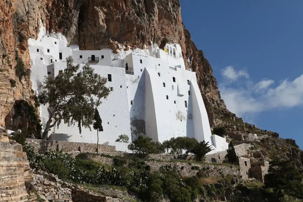 The long white monastery of Hozoviotissa built into a sheer brown cliff face on Amorgos